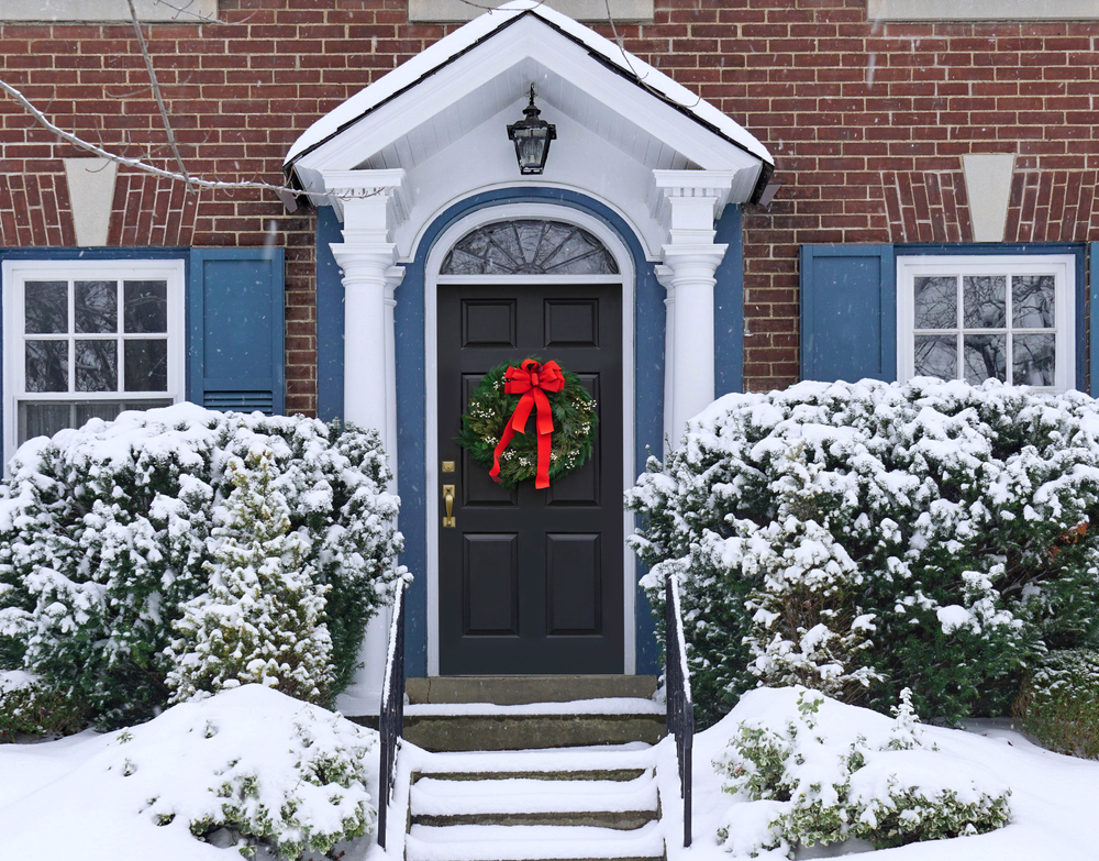 Front,Door,Of,House,With,Christmas,Wreath,And,Snow,Covered